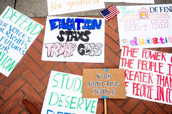 Signs rest on the ground at the University of California, Berkeley during a Day of Action for Higher Education protest against the Trump administration on Thursday, April 17, 2025, in Berkeley, Calif. (AP Photo/Noah Berger)