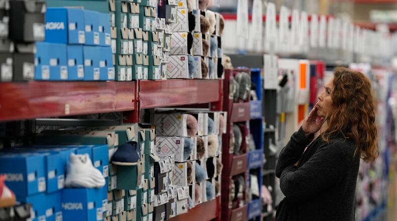A woman looks at shoes at a Sam's Club, Wednesday, Sept. 24, 2025, in Bentonville, Ark. (AP Photo/Charlie Riedel)