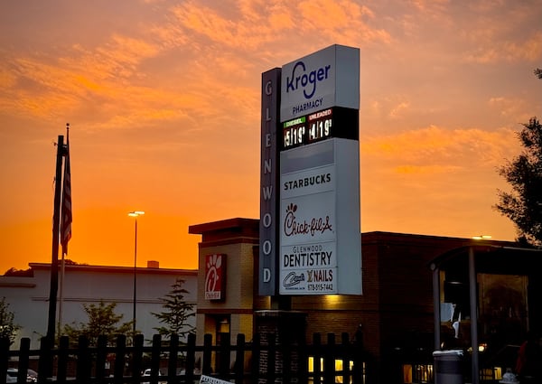 The exterior of a chickfila and shopping center sign for a development anchored by Kroger.