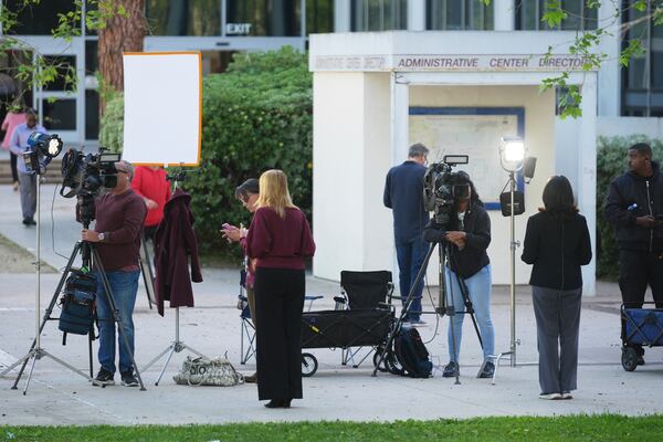 Media stage outside the Van Nuys West Courthouse before a hearing regarding the case of Erik and Lyle Menendez Friday, April 11, 2025, in Los Angeles. (AP Photo/Damian Dovarganes)