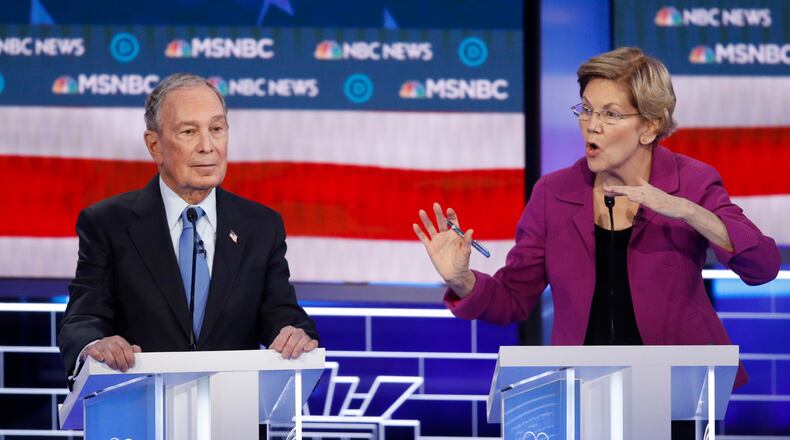 Democratic presidential candidates, former New York City Mayor Mike Bloomberg, left, listens as Sen. Elizabeth Warren, D-Mass., speak during a Democratic presidential primary debate Wednesday, Feb. 19, 2020, in Las Vegas, hosted by NBC News and MSNBC. (AP Photo/John Locher)