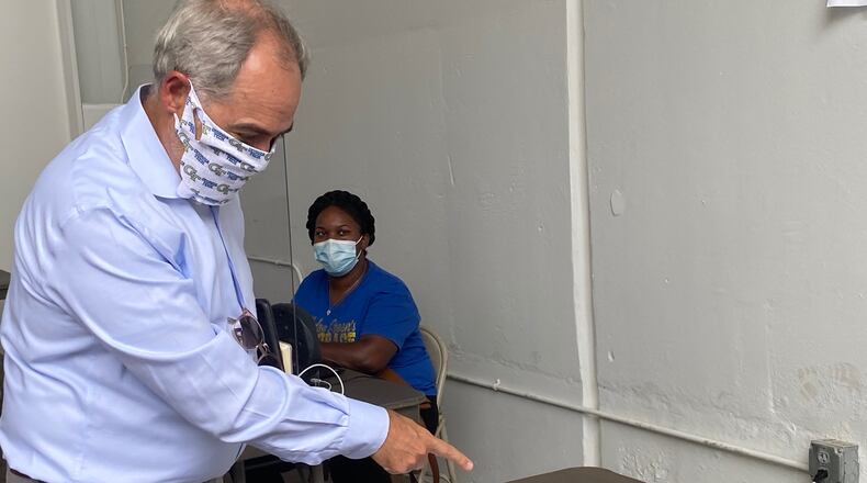 Georgia Tech President Angel Cabrera shows kits for used to test students and employees for COVID-19. ERIC STIRGUS/ERIC.STIRGUS@AJC.COM.