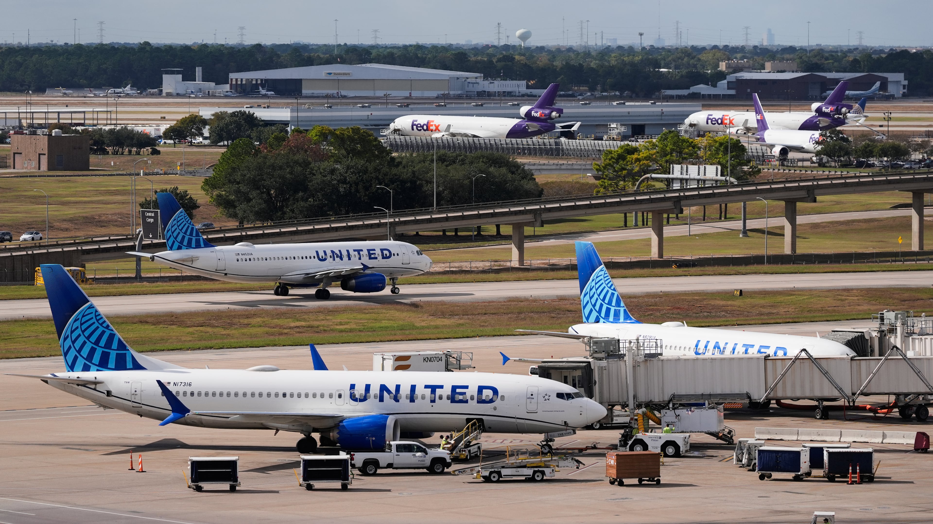 United Airlines and FedEx prepare for departure at George Bush Intercontinental Airport on Friday, Nov. 7, 2025, in Houston. (AP Photo/Ashley Landis)