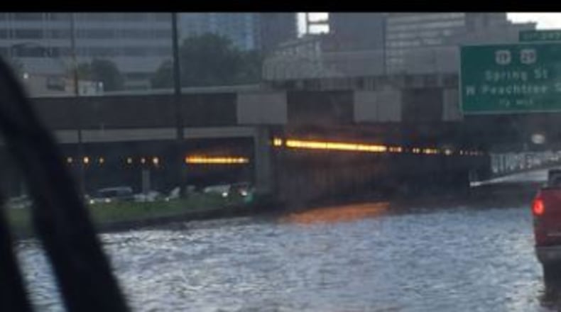 Both directions of the Downtown Connector were closed Sunday afternoon due to flooding from clogged drains. (Credit: Monica Richardson)