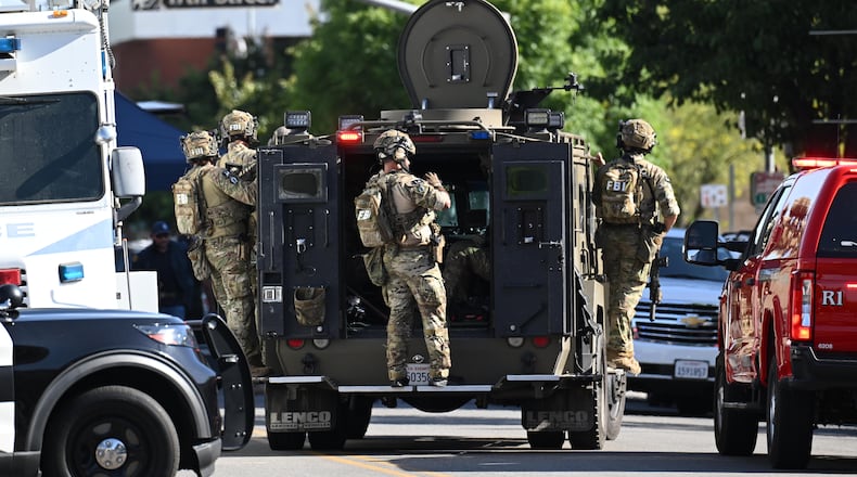 FBI agents respond after a man barricaded himself inside a building with hostages Tuesday, June 2, 2026, in Bakersfield, Calif. (AP Photo/David Dennis)