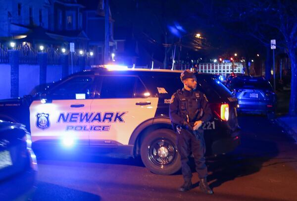 Law enforcement officers investigate the scene after two police officers were shot in Newark, N.J., on Friday, March 7, 2025. (Ed Murray/NJ Advance Media via AP)