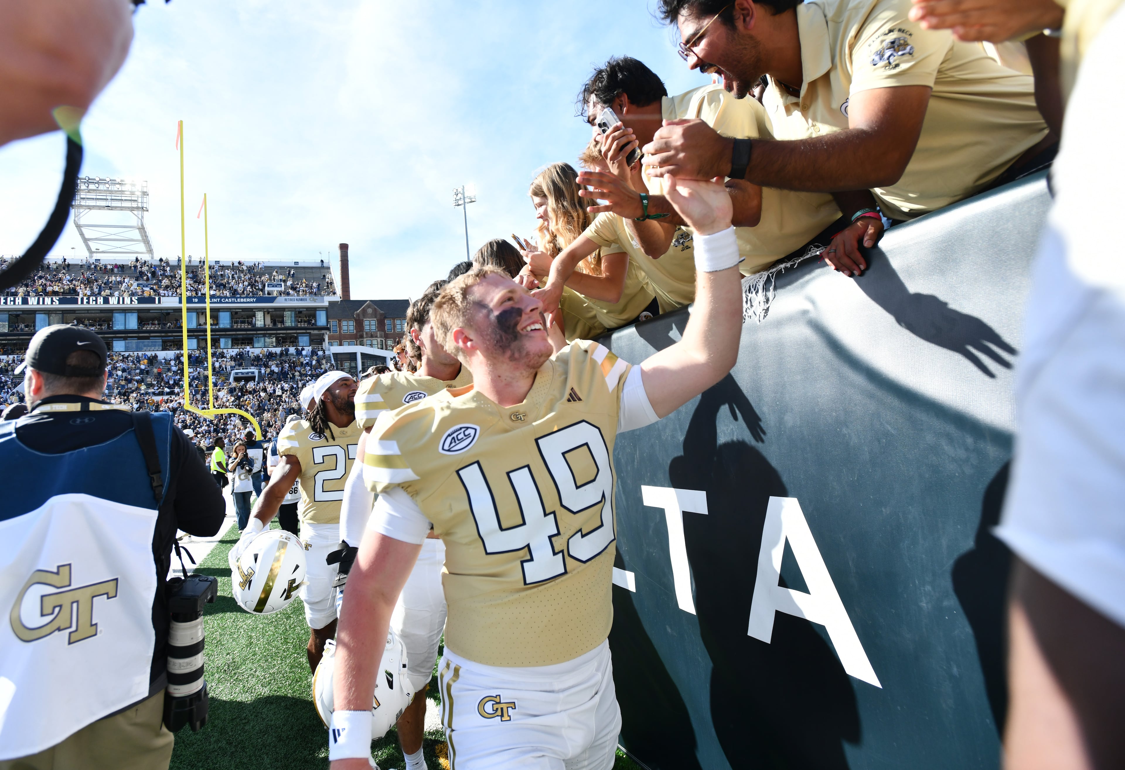 Georgia Tech players celebrate with fans after Georgia Tech beat Syracuse during an NCAA college football game at Bobby Dodd Stadium, Saturday, Oct. 25, 2025 in Atlanta. Georgia Tech won 41-16 over Syracuse. The Yellow Jackets are 8-0 for the first time since 1966 and 5-0 in the ACC for the first time ever. (Hyosub Shin/AJC)