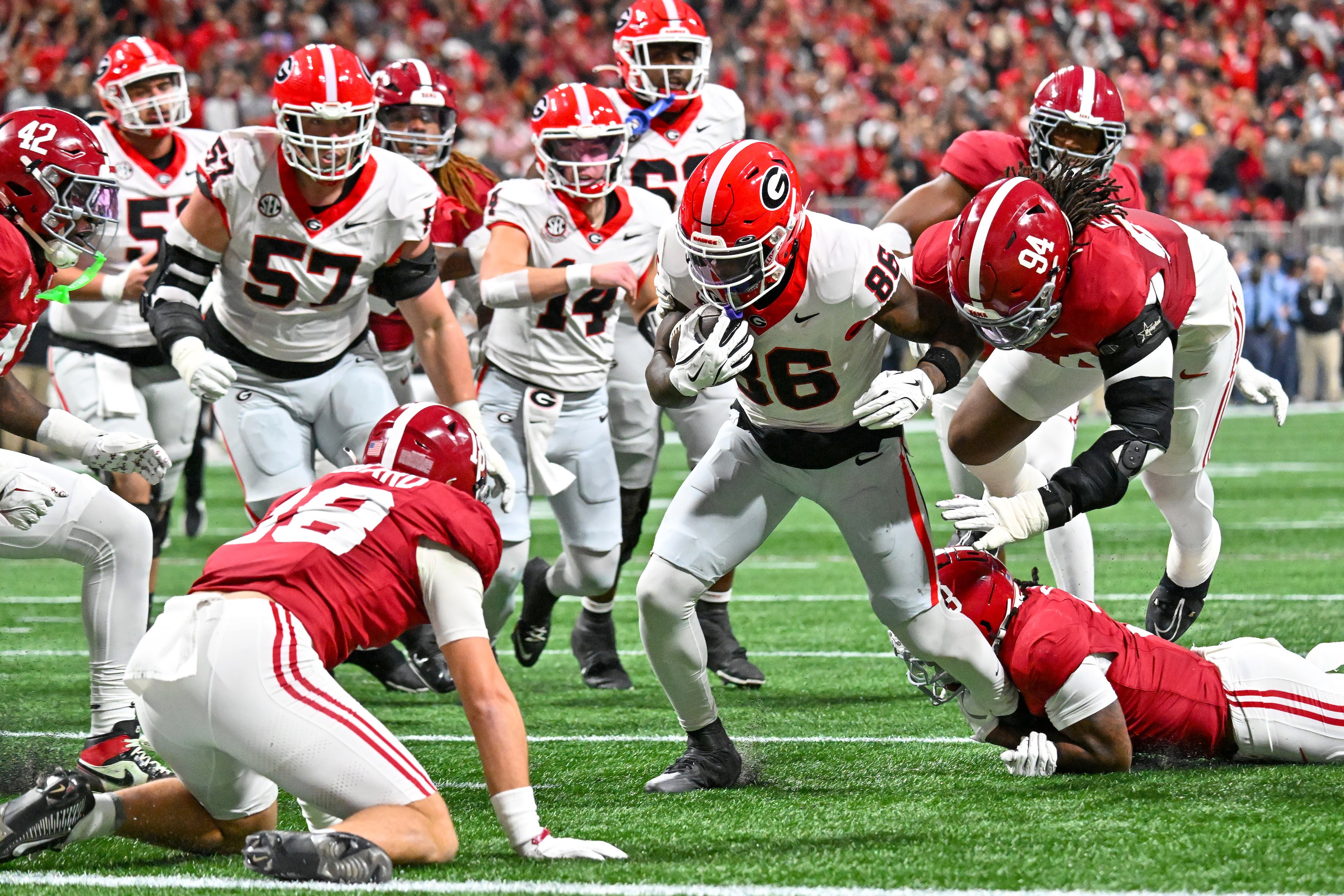 Georgia wide receiver Dillon Bell (86) is pursued by Alabama defensive lineman Edric Hill (94) during the first quarter of the SEC Championship game at Mercedes-Benz Stadium, Saturday, Dec. 6, 2025, in Atlanta. (Hyosub Shin / AJC)