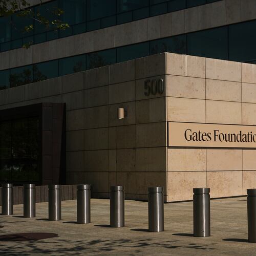 FILE - A person walks outside of the Gates Foundation campus Wednesday, April 30, 2025, in Seattle. (AP Photo/Lindsey Wasson, File)