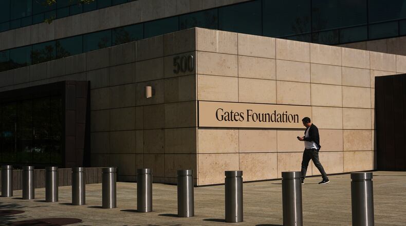 FILE - A person walks outside of the Gates Foundation campus Wednesday, April 30, 2025, in Seattle. (AP Photo/Lindsey Wasson, File)