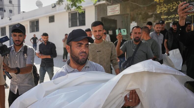 Mourners carry the bodies of two Palestinian girls Zeina Safadi, and her sister Lana, who were killed during an overnight Israeli airstrike that damaged their home, during their funeral in Gaza city, Saturday, June 20, 2026. (AP Photo/Abdel Kareem Hana)