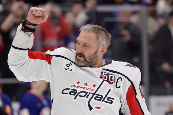 Washington Capitals left wing Alex Ovechkin (8) celebrates after scoring his 895th career goal during the second period of an NHL hockey game against New York Islanders in Elmont, N.Y., Sunday, April 6, 2025. (AP Photo/Adam Hunger)