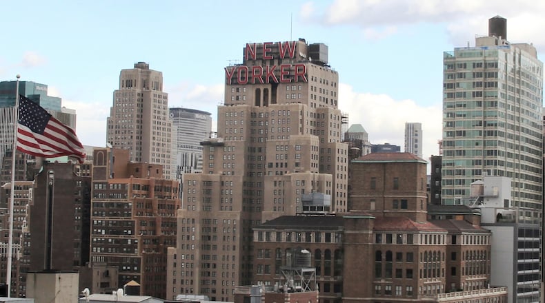 FILE - The New Yorker Hotel, center, is seen in New York, Nov. 8, 2013. A man who succeeded in using a New York City housing law to live rent-free in the iconic hotel has been charged with fraud after he claimed to own it. (AP Photo/Peter Morgan, File)