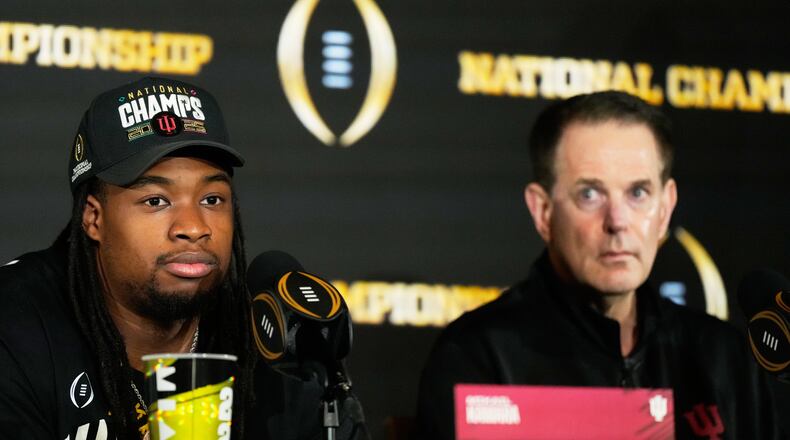 Indiana defensive lineman Mikail Kamara speaks as head coach Curt Cignetti looks on during the champions news conference after theiir win against Miami in the College Football Playoff national championship game, Tuesday, Jan. 20, 2026, in Miami. (AP Photo/Chris Carlson)