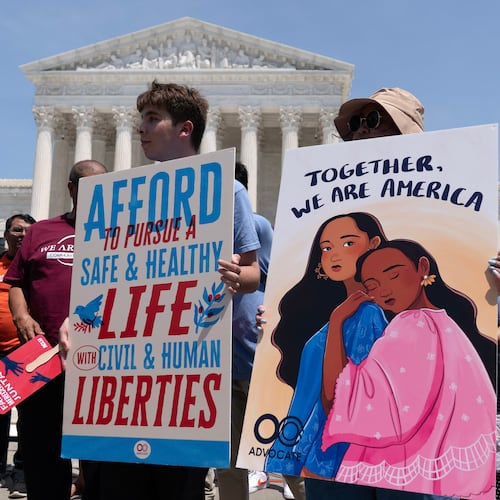 Activists celebrate the Supreme Court's ruling on birthright citizenship, outside of the Supreme Court on Capitol Hill, Tuesday, June 30, 2026, in Washington. (AP Photo/Jose Luis Magana)