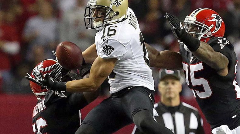 November 29, 2012 - Atlanta, Ga: New Orleans Saints wide receiver Lane Moore (16) makes a catch in between Atlanta Falcons defenders Sean Weatherspoon, left, and William Moore in the first half of their game at the Georgia Dome Thursday night in Atlanta, Ga., November 29, 2012. JASON GETZ / JGETZ@AJC.COM