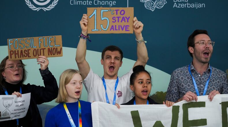 FILE - Activists participate in a demonstration for phasing out fossil fuels at the COP29 U.N. Climate Summit, Nov. 19, 2024, in Baku, Azerbaijan. (AP Photo/Sergei Grits, File)