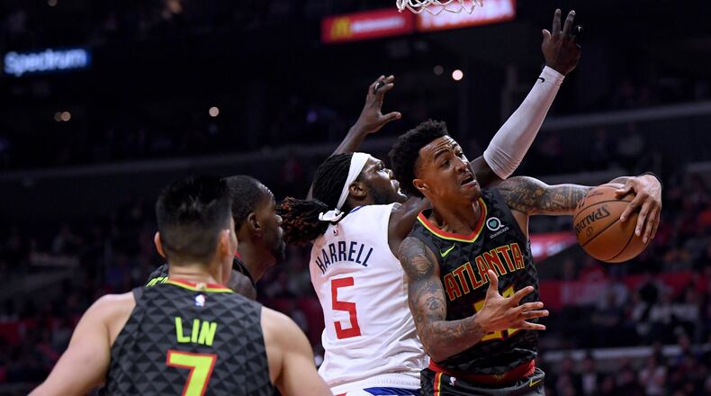 John Collins of the Atlanta Hawks takes a rebound from Montrezl Harrell of the LA Clippers during a 123-118 Hawks win at Staples Center on January 28, 2019 in Los Angeles, California. (Photo by Harry How/Getty Images)