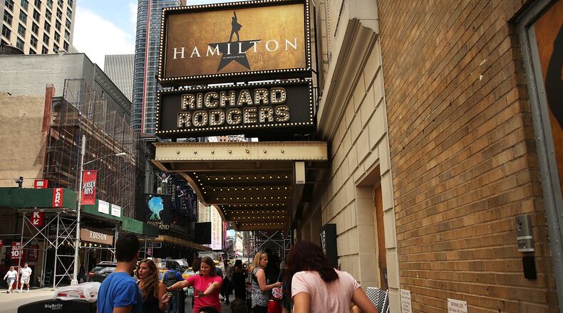 People, many who have been there for days, wait in line with dozens of others for tickets for the popular Broadway show Hamilton on June 21, 2016 in New York City. The Tony Award-winning Broadway hit has drawn huge crowds to the Richard Rogers theater in tin he hopes of getting increasingly scarce and expensive tickets. Carrying bed rolls, pillows and take-out food containers, many fans of the musical wait days in the heat and rain for a chance to get a cancellation ticket which are offered to the public once they're declined by members of the cast and crew. (Photo by Spencer Platt/Getty Images)