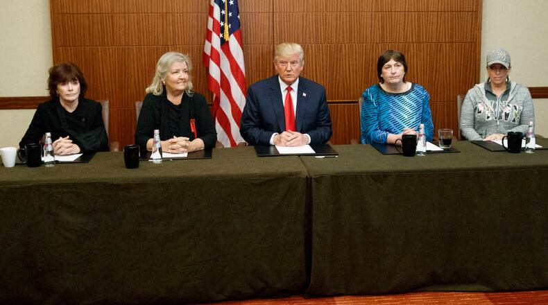 Republican presidential candidate Donald Trump, center, sits with, from right, Paula Jones, Kathy Shelton, Juanita Broaddrick, and Kathleen Willey, before the second presidential debate with democratic presidential candidate Hillary Clinton at Washington University, Sunday, Oct. 9, 2016, in St. Louis. (AP Photo/ Evan Vucci)