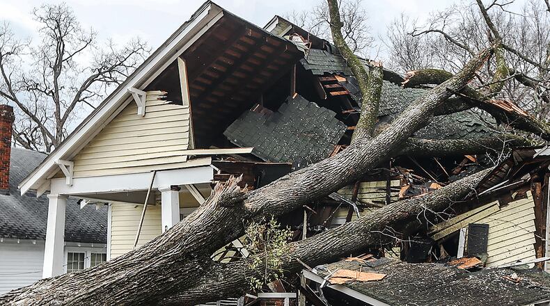 Adam Smith with Green Tree Service surveys the damage on West Chappell Street in Griffin on Jan. 13.