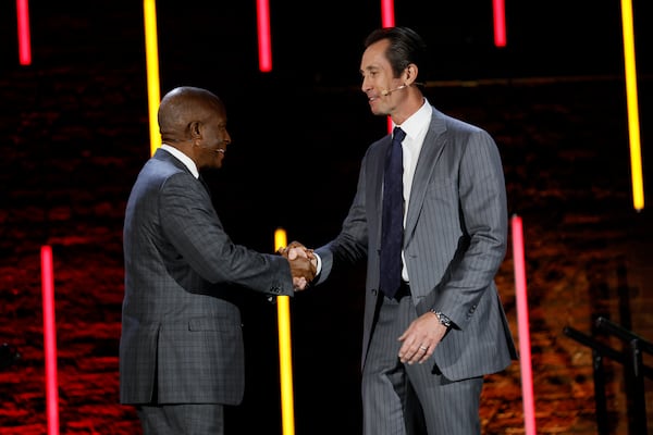 President and CEO of Southern Company Chris Womack shakes hands with President and CEO of PulteGroup Ryan Marshall as he hands him the leadership role of Metro Atlanta Chamber Board Chair during the MAC annual meeting at the Fright Depot on Wednesday, Nov. 21, 2024.
 (Miguel Martinez/AJC)