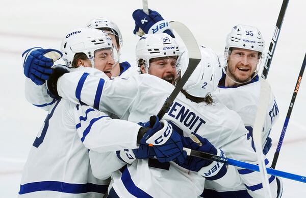 Toronto Maple Leafs' Matthew Knies (23) celebrates after the winning goal with teammates Simon Benoit (2), Auston Matthews (34) and Oliver Ekman-Larsson (95) during overtime against the Ottawa Senators in Game 3 of the first round of NHL hockey playoff series action in Ottawa, Ontario, Thursday, April 24, 2025. (Adrian Wyld/The Canadian Press via AP)