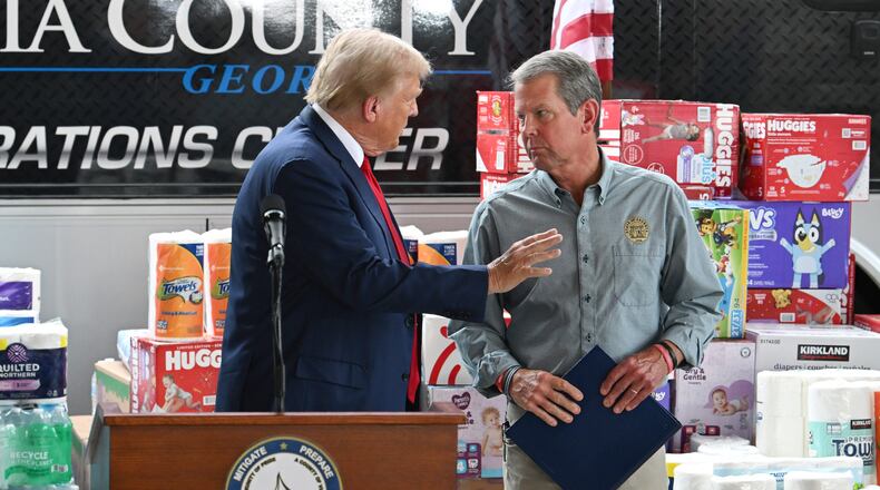 Donald Trump, left, greets Gov. Brian Kemp during an October tour to survey damage in east Georgia from Hurricane Helene. Trump's pending return to the White House could produce numerous changes to the political landscape in Georgia, including whether Kemp pursues a campaign for the U.S. Senate. (Hyosub Shin / AJC)