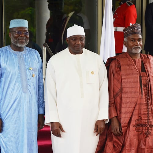 FILE - Omar Touray, president of the ECOWAS Commission, left, Gambia's President Adama Barrow,, center and Nigeria Minister of Foreign Affairs, Yusuf Tuggar pose for a photo, prior to the start of the ECOWAS meeting in Abuja, Nigeria, Sunday, June 22, 2025. (AP Photo/Olamikan Gbemiga, file)