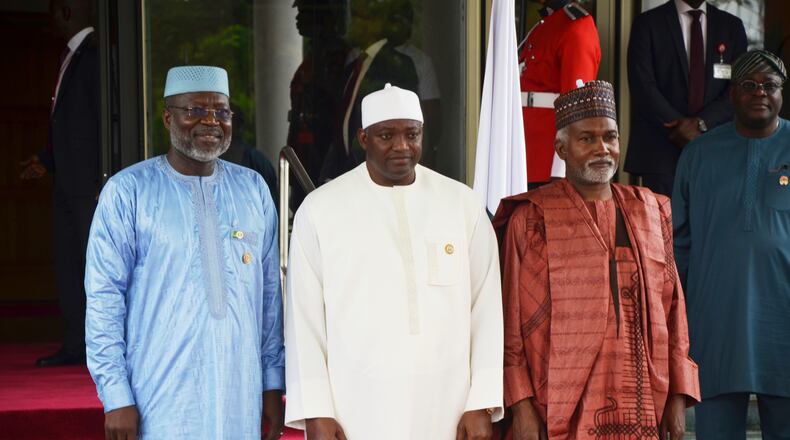 FILE - Omar Touray, president of the ECOWAS Commission, left, Gambia's President Adama Barrow,, center and Nigeria Minister of Foreign Affairs, Yusuf Tuggar pose for a photo, prior to the start of the ECOWAS meeting in Abuja, Nigeria, Sunday, June 22, 2025. (AP Photo/Olamikan Gbemiga, file)
