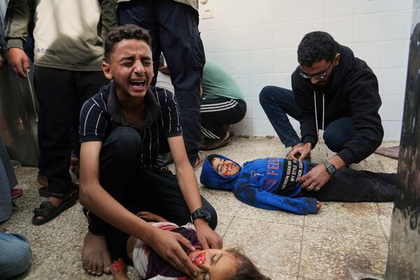 EDS NOTE: GRAPHIC CONTENT - Samy Abed, left, mourns his sister Massa Abed, 4, who was killed in an Israeli army airstrike on the Gaza Strip, at the morgue of Al-Aqsa Hospital in Deir al-Balah, Gaza, Sunday, April 27, 2025. (AP Photo/Abdel Kareem Hana)