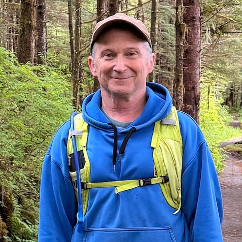 In this image provided by Karen Dillman, Alaska Senate candidate Dan Sullivan, one of the challengers to the incumbent senator, also named Dan Sullivan, poses for a photo on a hike, Sunday, June 7, 2026, on Kupreanof Island, near Petersburg, Alaska. (Karen Dillman via AP)