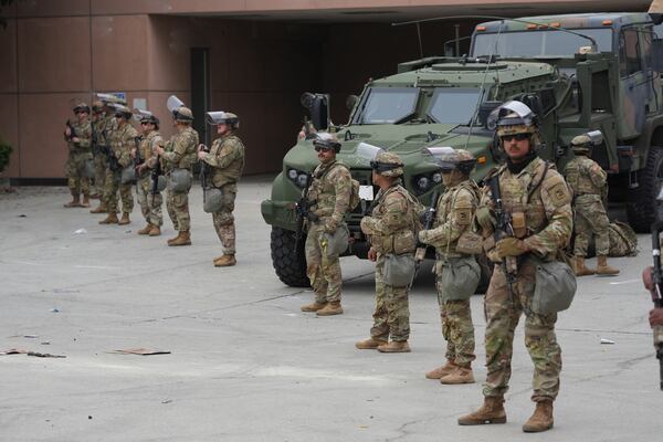 U.S. National Guard are deployed outside the federal prison in downtown Los Angeles, Sunday, June 8, 2025, following a immigration raid protest the night before. (AP Photo/Jae Hong)