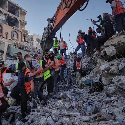 Palestinian civil defense crews carry a body from the rubble of a collapsed building that housed displaced Palestinians and was heavily damaged during the Israel-Hamas war, in Gaza City, Wednesday, Sept. 16, 2026. (AP Photo/Jehad Alshrafi)