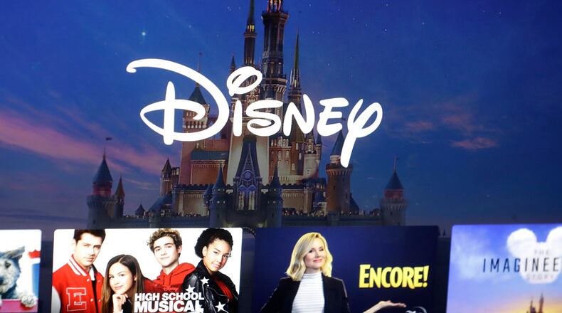 FILE - In this Nov. 13, 2019 file photo, a Disney logo forms part of a menu for the Disney Plus movie and entertainment streaming service on a computer screen in Walpole, Mass. (AP Photo/Steven Senne, File)