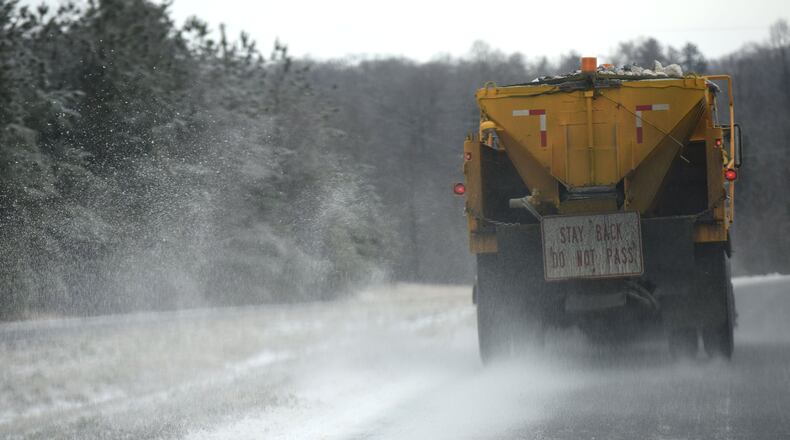 GDOT truck spreads gravel and salt on I-985 northbound near Gainesville last year. HYOSUB SHIN / HSHIN@AJC.COM AJC File Photo