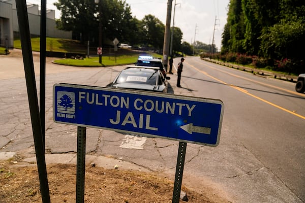 FILE - A Fulton County Jail signs points to where the jail is located, Aug. 24, 2023, in Atlanta. (AP Photo/Brynn Anderson, File)