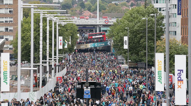 Spectators walk up Wembley Way as they arrive for an NFL football game between the Miami Dolphins and the New Orleans Saints at Wembley Stadium in London, Sunday Oct. 1, 2017. (AP Photo/Tim Ireland)
