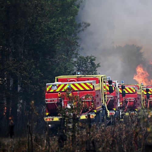 Firefighters tackle a blaze as wildfires rage near Le Las, outside Bordeaux, France, Monday, July 27, 2026. (AP Photo/Emma Da Silva)