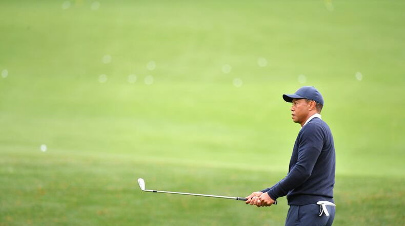 Tiger Woods chips on the range during practice Tuesday for the Masters. (Hyosub Shin / Hyosub.Shin@ajc.com)