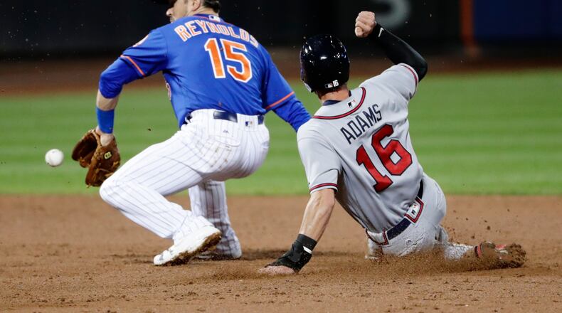 Atlanta Braves' Lane Adams (16) slides past New York Mets Matt Reynolds (15) to steal second base during the third inning of the second baseball game of a doubleheader, Monday, Sept. 25, 2017, in New York. (AP Photo/Frank Franklin II)