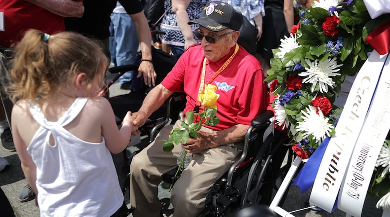WASHINGTON, DC - JUNE 06: A little girl shakes hands with World War II veteran Jose Baldonado during a wreath laying ceremony at the National World War II Memorial on the National Mall on the 75th anniversary of D-Day, or Operation Overlord, June 06, 2019 in Washington, DC. (Photo by Chip Somodevilla/Getty Images)
