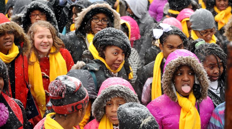 JANUARY 28, 2014 ATLANTA Students attending a school choice rally at the Georgia Capitol try to catch snowflakes Tuesday. Snow falling in metro Atlanta caused schools to close early and sent workers home at mid-day, causing gridlock in downtown Atlanta, Tuesday, January 28, 2014. KENT D JOHNSON/KDJOHNSON@AJC.COM Georgia students attend a school choice rally in Atlanta, January 2014. (AJC/Kent D. Johnson)