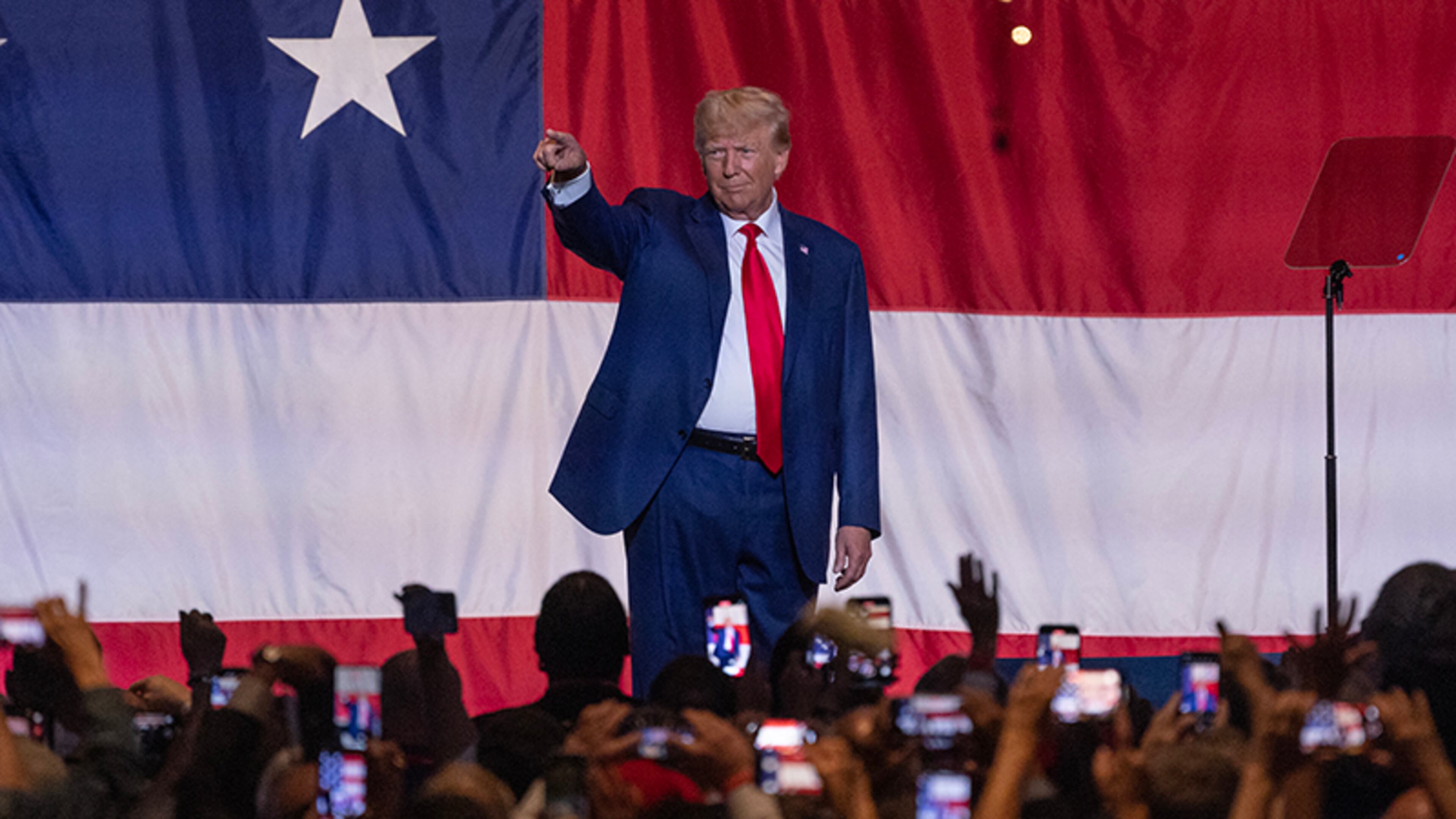 President Donald Trump waves to supporters before speaking during the GOP Convention at the Columbus Georgia Convention & Trade Center on June 10, 2023. (Natrice Miller/AJC)