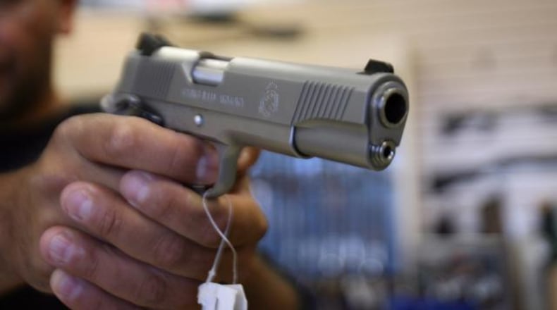 A man purchases a gun at a store in Glendale California. AFP PHOTO/GABRIEL BOUYS