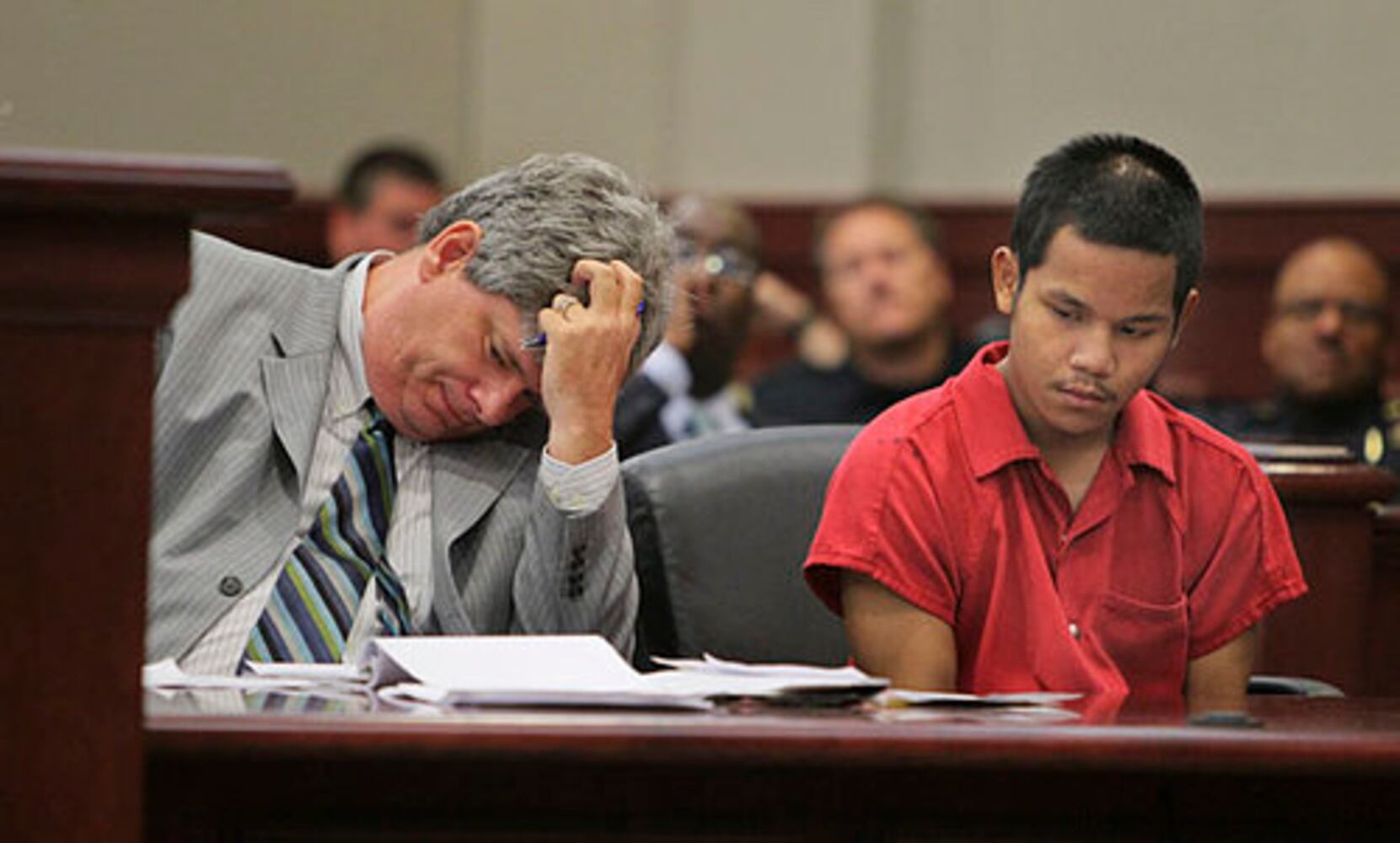 Teen in court, accused of killing cop