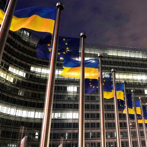 FILE - The European Union and Ukrainian flags flap in the wind to mark the third anniversary of Russia's full-scale invasion of Ukraine outside EU headquarters in Brussels, Feb. 24, 2025. (AP Photo/Virginia Mayo, File)