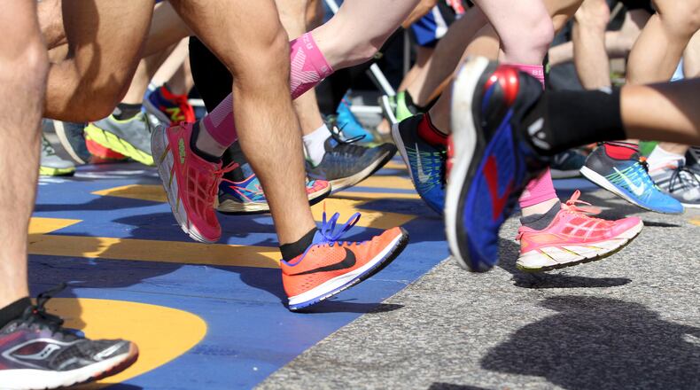FILE - A colorful collection of shoes cross the starting line at the start of the 2017 Boston Marathon in Hopkinton, Mass., Monday, April 17, 2017. (AP Photo/Mary Schwalm, file)