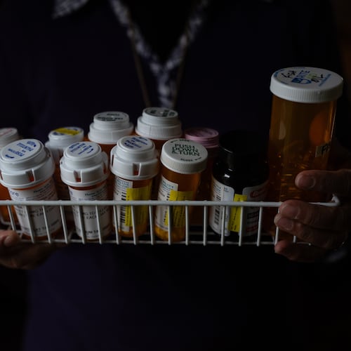 Masuma Khan, an immigrant from Bangladesh who was held at an immigration detention facility in California City the previous year, holds the medications she takes daily, in Altadena, Calif., April 21, 2026. (AP Photo/Jae C. Hong)