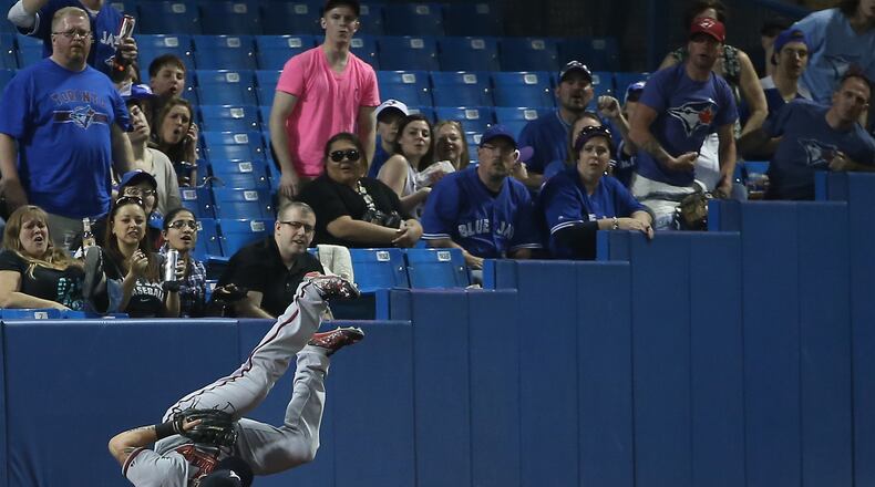 Jonny Gomes #7 of the Atlanta Braves cannot get to a foul ball in the third inning during MLB game action against the Toronto Blue Jays on April 18, 2015 at Rogers Centre in Toronto, Ontario, Canada. (Photo by Tom Szczerbowski/Getty Images)